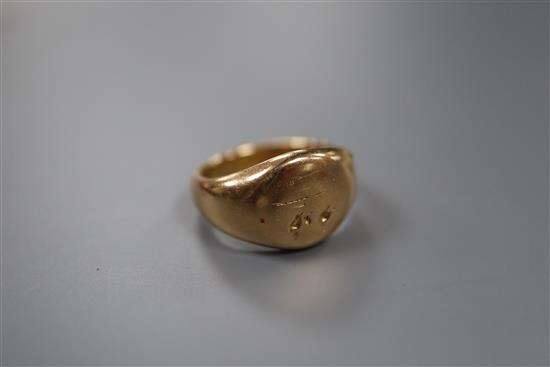 An early 20th century 18ct gold signet ring (worn) and an 18ct, plat and mother of pearl part stud set.